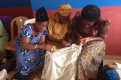 Widows prepare fabric for dyeing